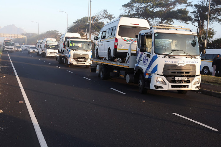 Traffic officials impound vehicles during last month’s violent taxi strike in Cape Town.