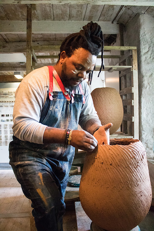 Andile Dyalvane working at Leach studio.