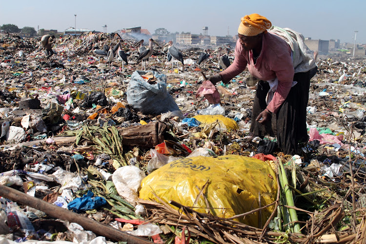 A woman collects and sorts waste at Dandora dumpsite