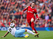 Andrew Robertson of Liverpool runs past challenge of Joachim Andersen of Crystal Palace in the Premier League match at Anfield in Liverpool on Sunday. 