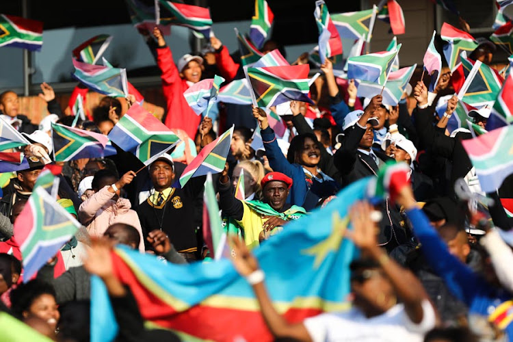 South Africans sing struggle songs as they gather to watch the presidential inauguration on 25 May 2019, at Loftus Stadium in Pretoria. ANC president Cyril Ramaphosa is set to take the oath of office as president of South Africa.