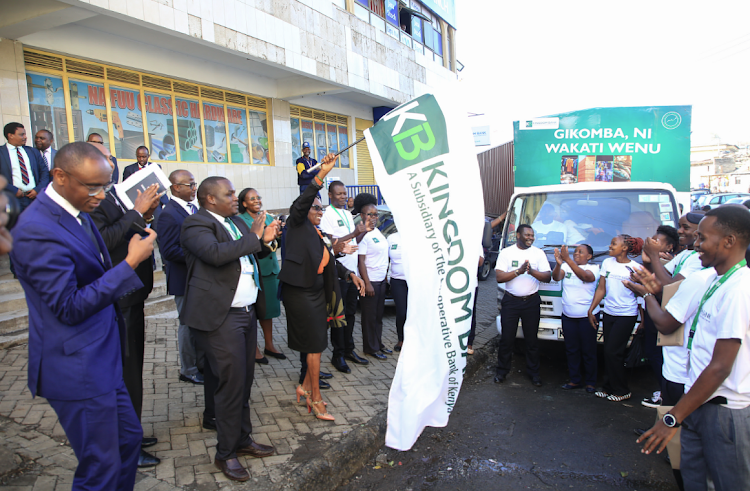 Kingdom Bank board chair Margaret Karangatha accompanied by bank staff flags off a market activation roadshow during the opening of the bank’s 20th branch in Gikomba. This expansion into Gikomba underscores Kingdom Bank’s strategic commitment to Micro, Small and Medium-sized businesses (MSMEs) where the bank holds significant domain expertise/ HANDOUT