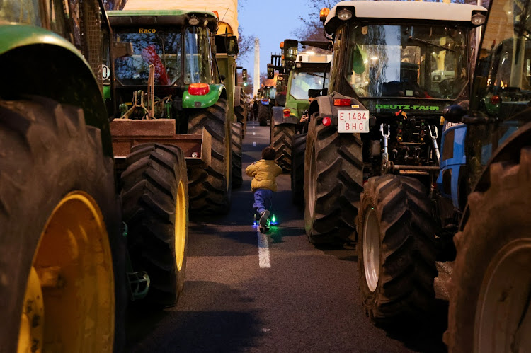 A child moves between tractors during a farmers protest over price pressures, taxes and green regulation, grievances shared by farmers across Europe, in Barcelona, Spain, on February 7 2024. Picture: NACHO DOCE/REUTERS