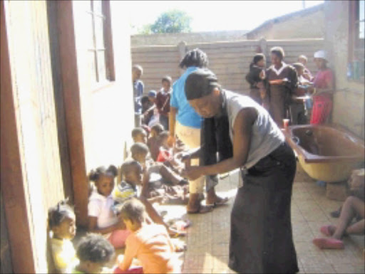 MEAL TIME: Children in Soweto have an afternoon meal at one of the Thandanani feeding scheme centres. 10/03/2010. © Sowetan.