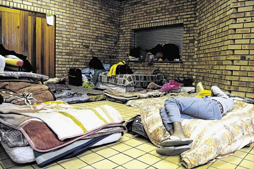 COOLING OFF: One nyaope addict sleeps on a bed with bedding donated by the community as he tries to wear off the drug at the makeshift rehabilitation camp at Ekangala Community Hall in Bronkhorstspruit Photo: Thulani Mbele