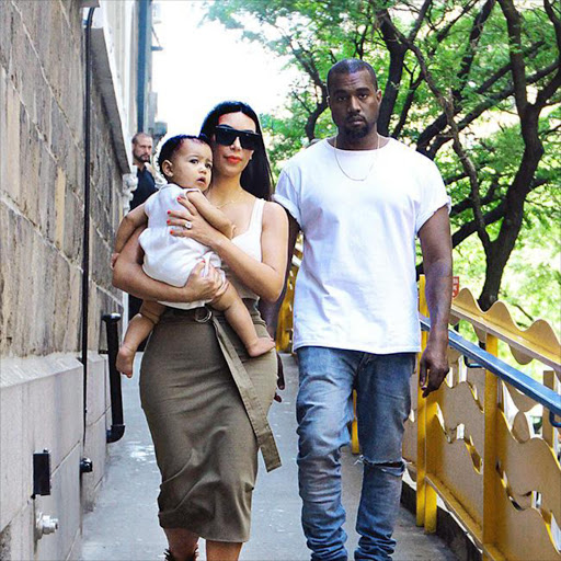 Kim Kardashian, Kanye West and baby North. File photo