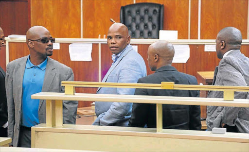 IN THE DOCK: Andile Fani, middle, after a tough court session at the East London Magistrate’s Court yesterday Picture: MARK ANDREWS