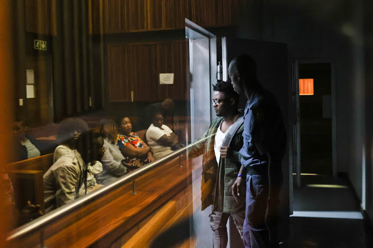 Flavio Hlabangwane walks into a holding cell after leaving the dock, 27 January 2023, during a high court sitting in the Palm Ridge Magistrates court, South of Johannesburg during his trail where he has pleaded guilty to murdering his girlfriend and placing her body parts in his fridge.