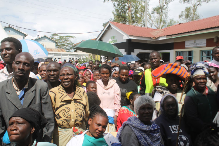 Residents brave chilly weather as they wait to receive governments' relief food during a donation drive at Athi River deputy county commissioner's office on April 25, 2024.