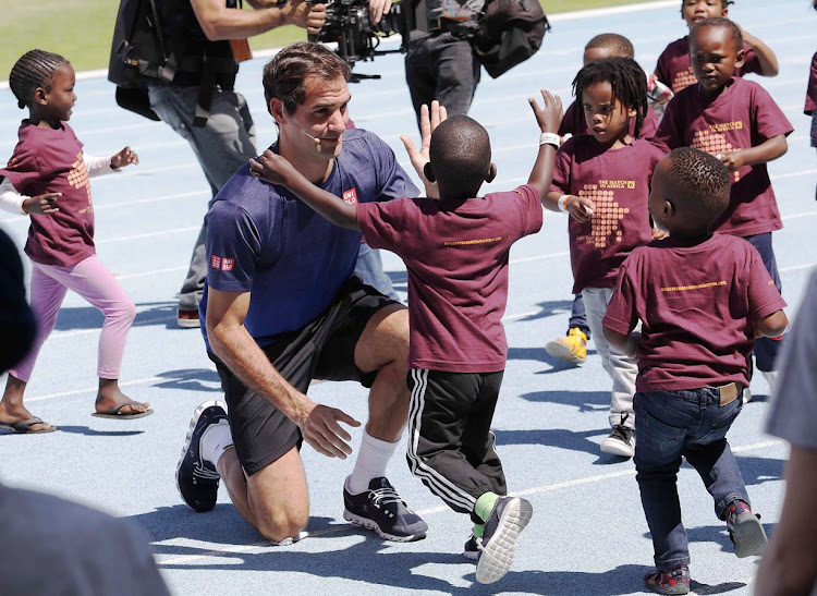 Roger Federer plays with children from Hangberg Pre-Primary School in Hout Bay at a 'learning through play' session at Green Point Athletics Stadium on February 7 2020.