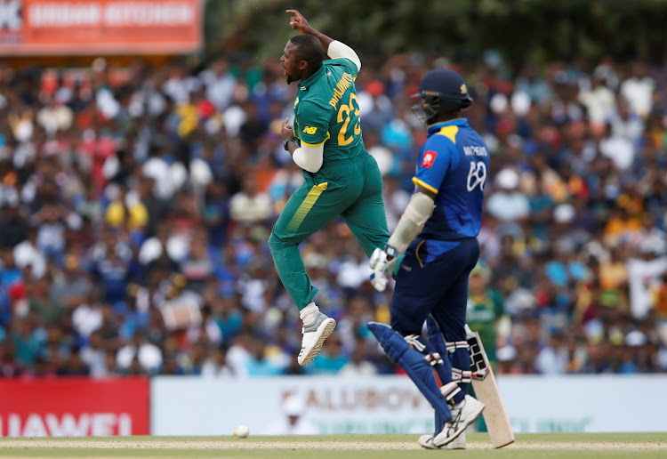 South Africa's Andile Phehlukwayo (L) celebrates after taking the wicket of Sri Lanka's Niroshan Dickwella (not pictured) during the Hero second of the five-match ODI series in Dambulla.
