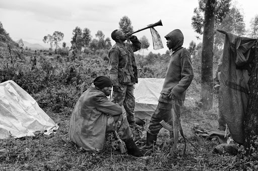 A Congolese soldier blows a South African vuvuzela to summon his comrades for a church service close to the frontline during the Battle of Kibati near Goma in the Democratic Republic of Congo.