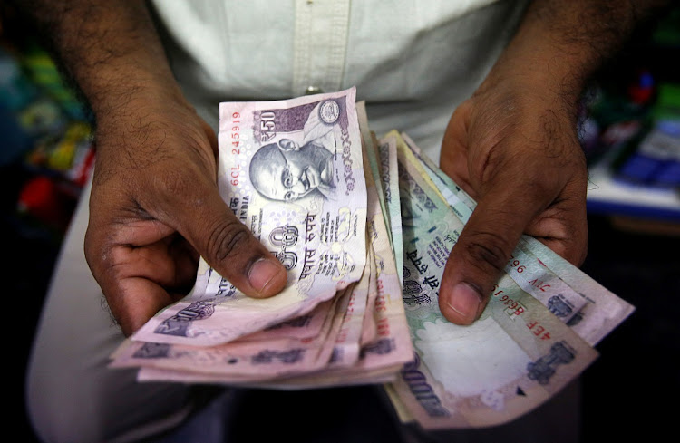 A private money trader counts Indian rupee currency notes at a shop in Mumbai, India. File photo: VIVEK PRAKASH/REUTERS