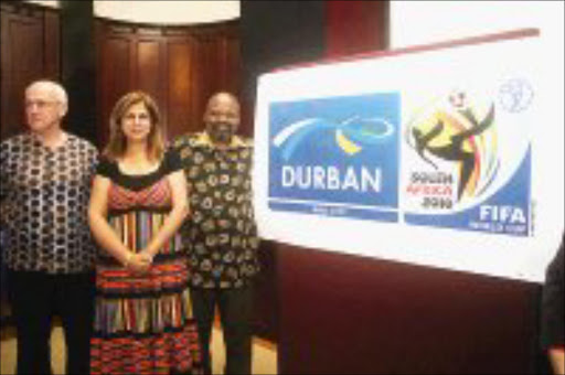 SEKUNJALO: eThekwini municipal manager Mike Sutcliffe, 2020 Strategic Projects and Programme head Julie-May Ellingson and executive mayor Obed Mlaba launch the host city logo in Durban yesterday. © Sowetan.