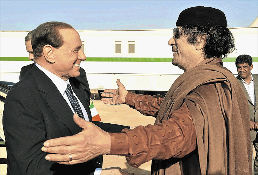 The late Libyan leader Muammar Gaddafi, right, with Italy's former prime minister and 'friend' Silvio Berlusconi.