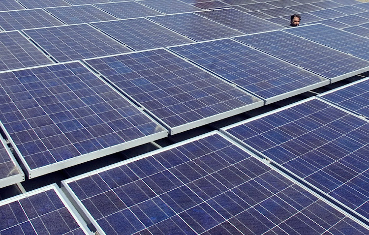 A man views solar panels on a roof at Google headquarters. File photo.