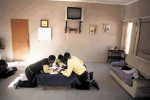 Pupils study around a table at an under-funded children's home in the Free State Picture: DANIEL BORN