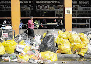 JUNK STATUS: As the Pikitup strike continues, rubbish is piling up in the Johannesburg CBD. Commuters on Bree Street brave the stench and dodge bags of garbage as they make their way up and down the street