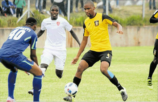 SHINING STAR: Mthatha Bucks defender Gift Sithole, with ball, makes sure his goalkeper Mlungisi Maranti is well protected during their match with Thanda Royal Zulu at the Mthatha Stadium. Sithole saved the day for Bucks with a late equaliser and Thanda remain unbeaten after eight matches Picture: ZINGISA MVUMVU