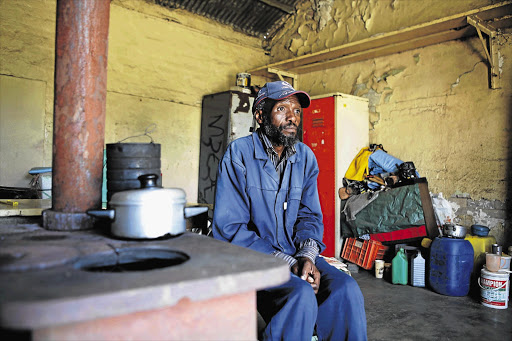 Paul Motloung, who worked at the troubled Grootvlei Mine and still stays in its hostel, has no electricity, running water or money to go home to Lesotho Picture: JAMES OATWAY
