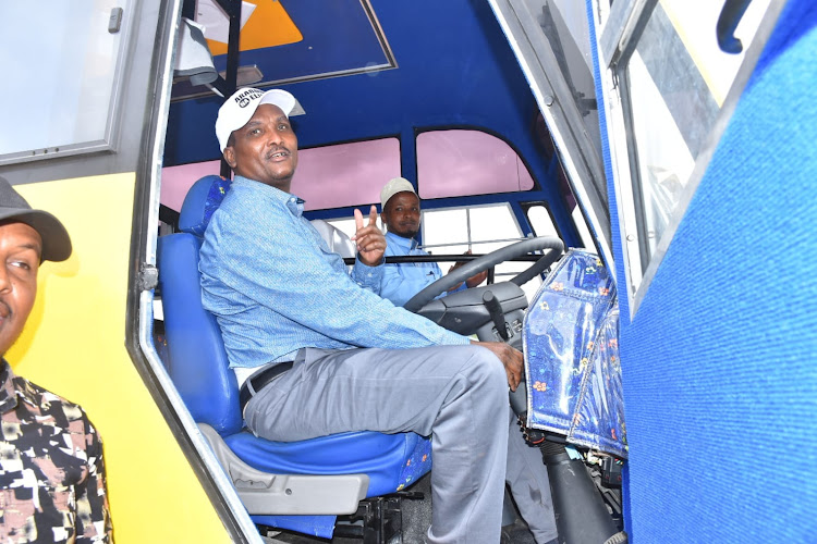 Lagdera MP Abdikadir Hussein tries out a new bus for Modogashe Secondary school that was purchased by the constituency kitty.
