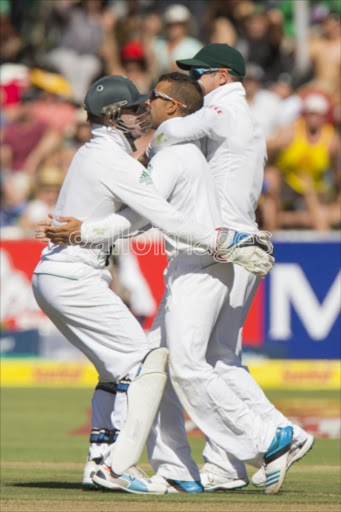 AB de Villers, JP Duminy and Faf du Plessis celbrating after the fall of David Warner's wicket during day 1 of the 3rd Test match between South Africa and Australia at Sahara Park Newlands on March 01, 2014.