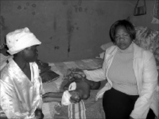 SHOCKING SCENE: ANC councillor Daily Maputla, right, with Angela Sehlako and her son Ablonia. 24/03/09. Pic. Alex Matlala. © Sowetan.