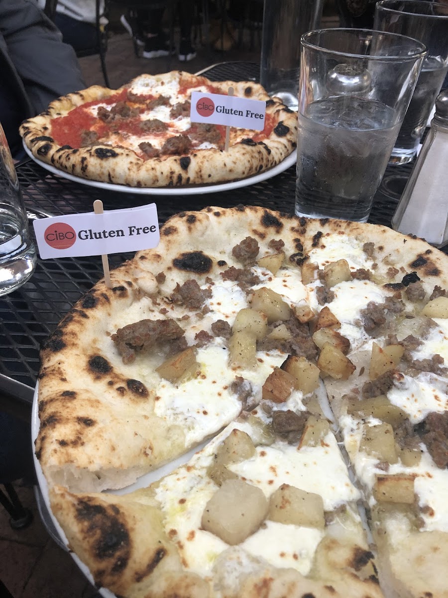 A delicious white pizza with roasted potatoes and GF sausage. And the sausage with red sauce is equally good.