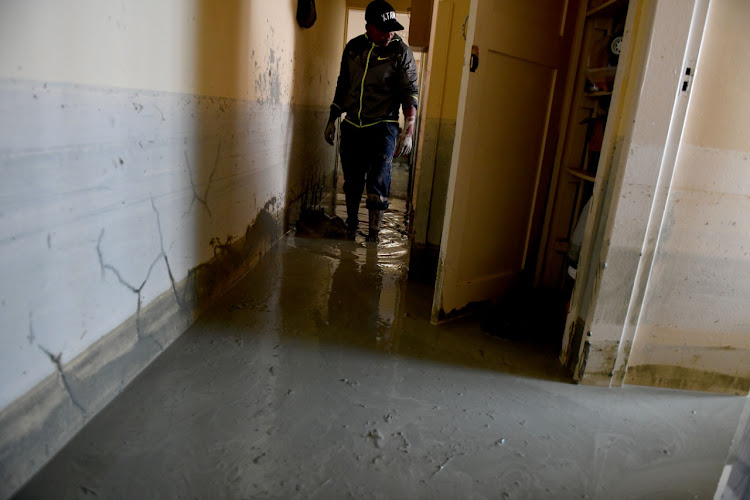 Mud from the collapse of the mine’s tailings dam wall swept into people's homes.