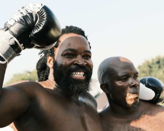Rapper Big Zulu wins his first boxing match against Brian Dings, right.