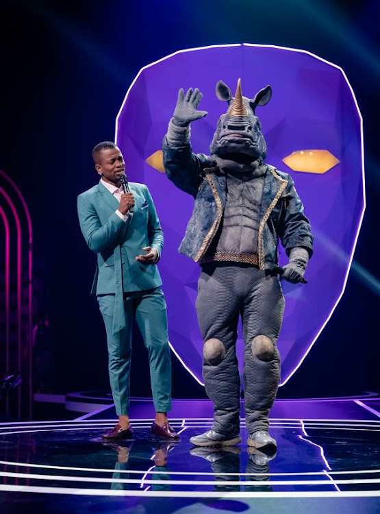 The Masked Singer host Mpho Popps on stage with Rhino.