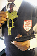 A security guard armed with a plastic gun containing two pepper-spray canisters: File photo