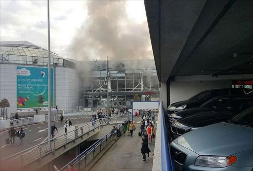 Reports of two blasts as smoke rises from terminal building at Brussels airport