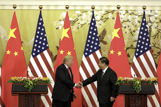 US President Donald Trump, left, and Chinese President Xi Jinping meet and greet at the Great Hall of the People in Beijing, China, in November 2017. The two countries are embroiled in a trade war that could result in a global power shift.