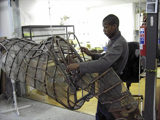 Ncedile Daki working on one of the puppets used in 'War Horse'.