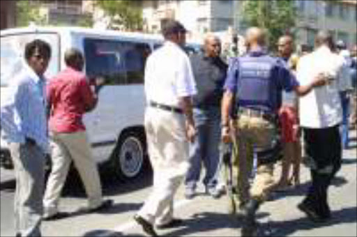 CLEANING UP: Metro police in Hillbrow during taxi violence. PIc. Mohau Mofokeng. 23/11/05. © Sowetan.