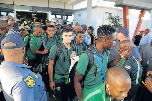 HEROES ARRIVE: Scores of supporters welcome Bafana Bafana at the East London airport yesterday. Bafana, who beat Guinea-Bissau 3-1 in Durban on Saturday, take on Angola in an international friendly at Buffalo City Stadium tomorrow at 7pm. The last time the national team played in East London was in 2003 l See page 16 for local fans’s views Picture: ALAN EASON