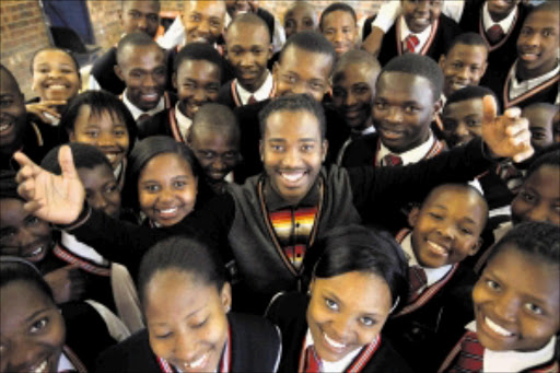 Xolani Mootane, centre, the composer of a special birthday song for Nelson Mandela, with pupils from Buhlebemfundo Secondary School in Tsakane on the East Rand. The children will be among the millions of pupils who, the Department of Education hopes, will sing the song at 8:05am tomorrow.