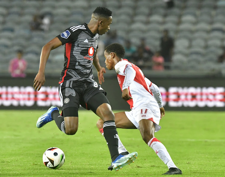 Asanele Velebayi of Cape Town Spurs is challenged by Mbatha Thalente of Orlando Pirates in their DStv Premiership match at Orlando Stadium on Wednesdy night.