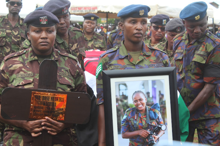 KDF soldiers carry the casket bearing the remains of fallen KDF Sergeant Rose Nyawira Wachira during her burial in Kagio Thursday