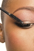 A woman applying mascara. File photo.