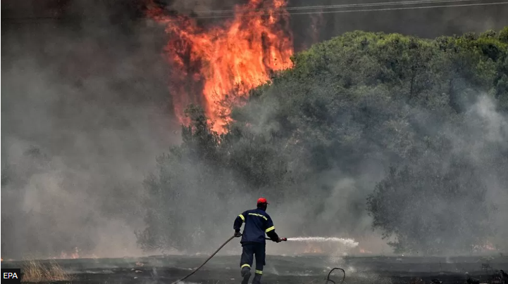 A firefighter tackles a wildfire in Loutraki, Greece