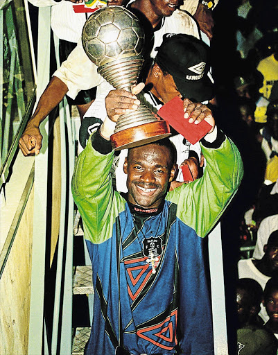 GLORY DAYS: Pirates goalkeeper Williams Okpara with the Caf Club Champions trophy in 1995