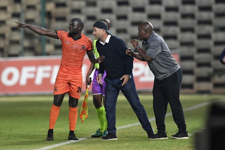 Polokwane City FC coach Jozef Vukusic is flanked by defender Simphiwe Hlongwane (L) and assistant coach Bernard Molekwa during the Absa Premiership match Bidvest Wits at Bidvest Stadium in Johannesburg on September 21, 2018.