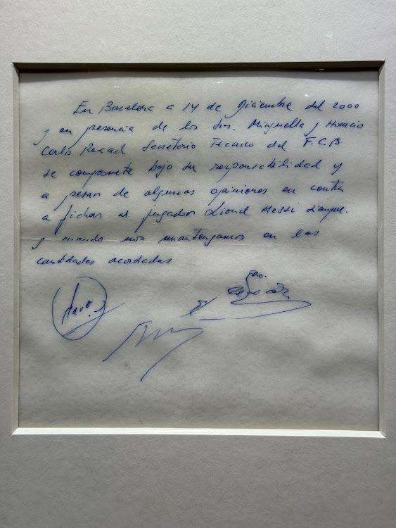 A signed and framed napkin on which soccer club Barcelona promised to sign a 13-year-old Lionel Messi is displayed at the Bonhams auction house in London, Britain May 8, 2024.