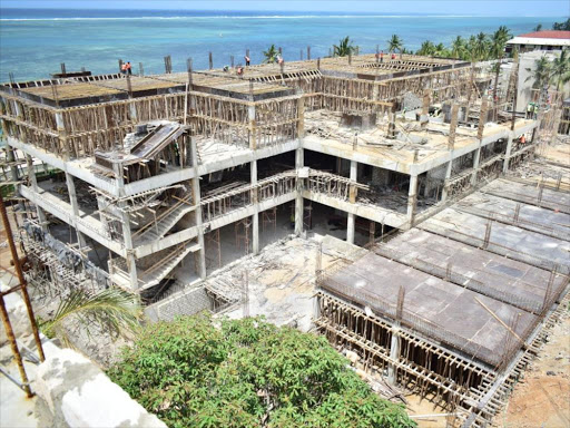 An aerial view of Dolphin Hotel which is under construction at the Indian Ocean beachfront, Mombasa, August 17, 2018. /JOHN CHESOLI