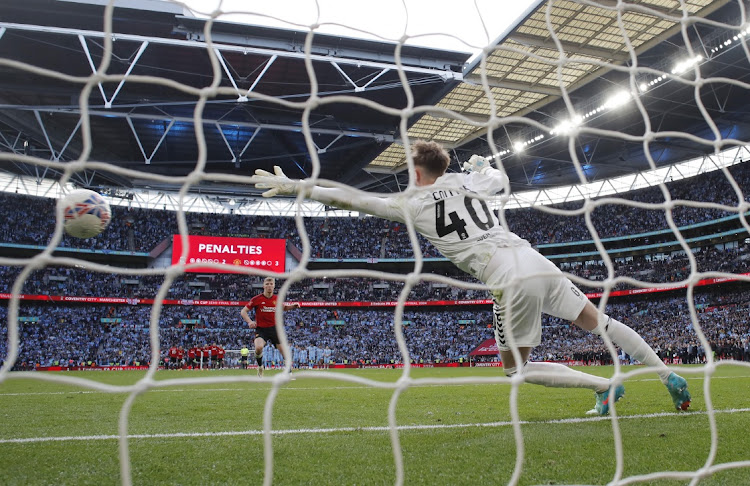 Manchester United's Rasmus Hojlund scores the winning penalty in the FA Cup semifinal shootout past Coventry City's Bradley Collins at Wembley Stadium, London on April 21, 2024