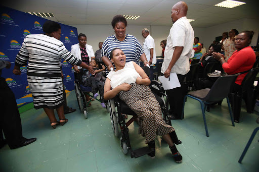 OFF THEY GO: Masibambisane residents showed their delight after receiving wheelchairs and blankets yesterday Picture: MARK ANDREWS