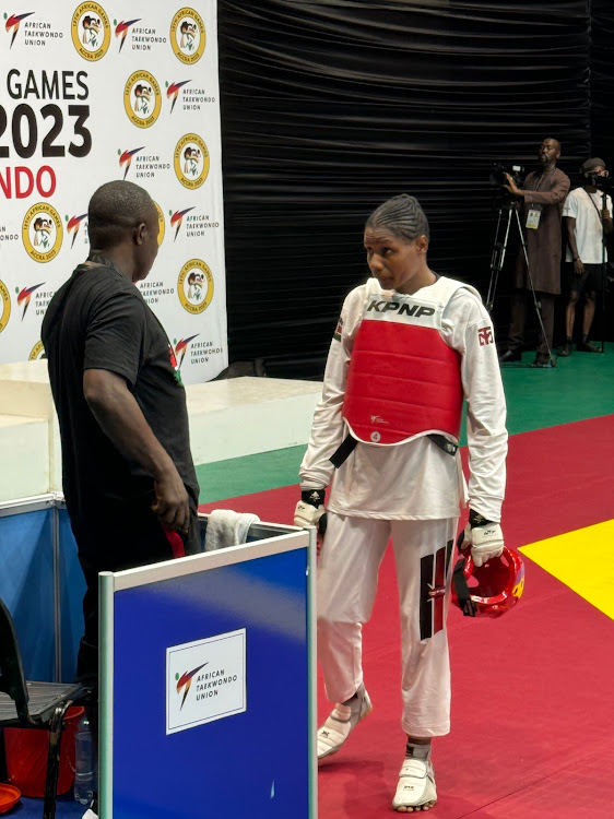 Faith Ogallo takes instructions from her coach during the fight