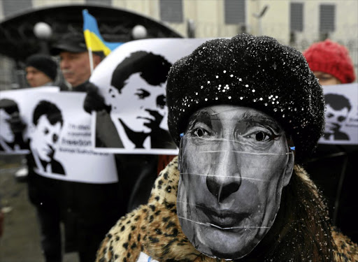 A masked activist at a rally in support of Roman Sushchenko, a Ukrainian detained in Russia on spying charges.